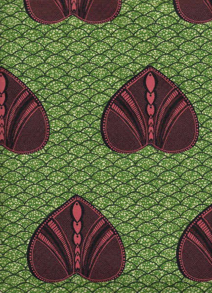Vibrant green African interior fabric with heart shaped pattern on polka dot background. Interior textile.