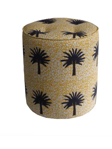 Vibrant yellow African print pouffe with large black and brown tropical palm tree  