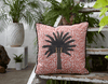 Colourful copper pink African batik print cushion with large tropical palm tree  