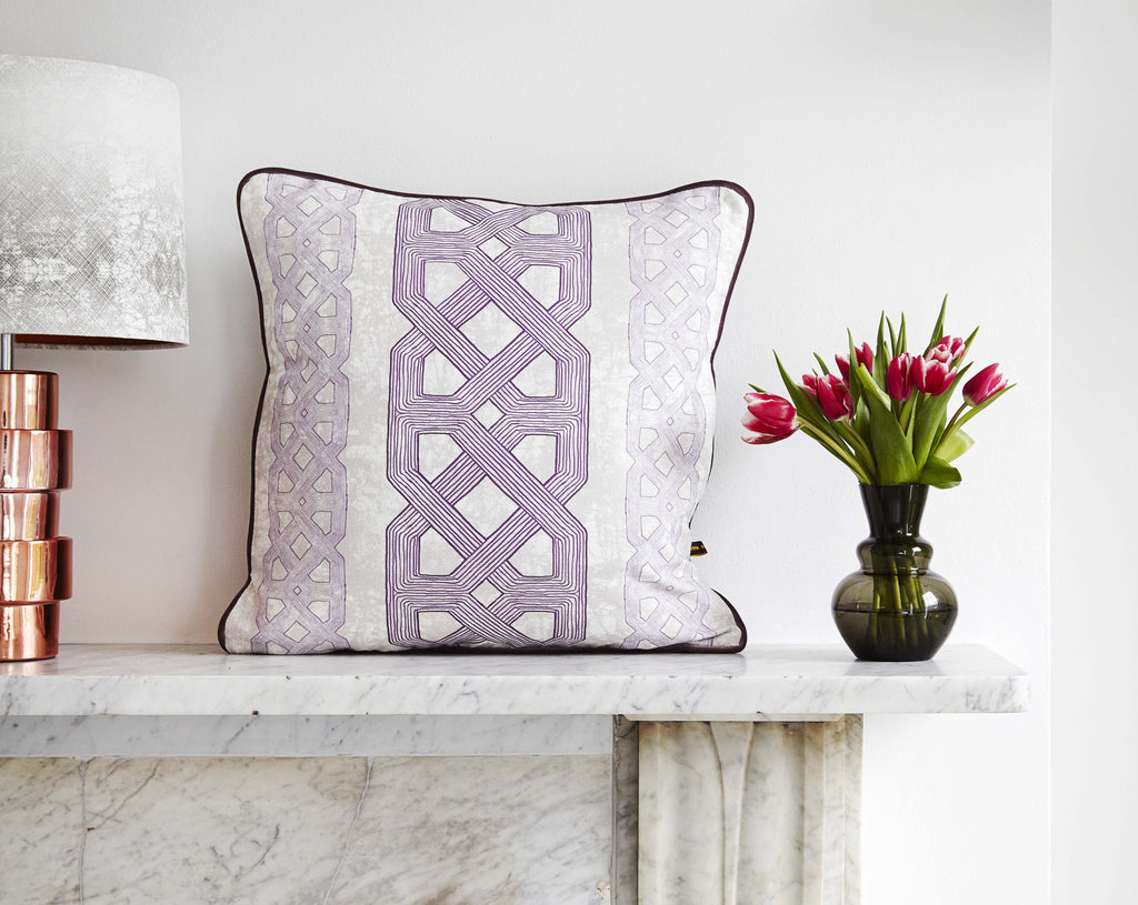 Elegant African batik print cushion with purple graphic pattern on batik base