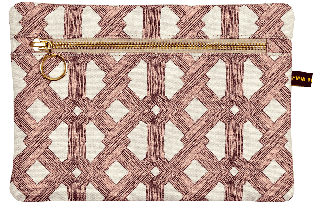 Luxury African batik print envelope bag with soft pink geometric pattern and gold zip