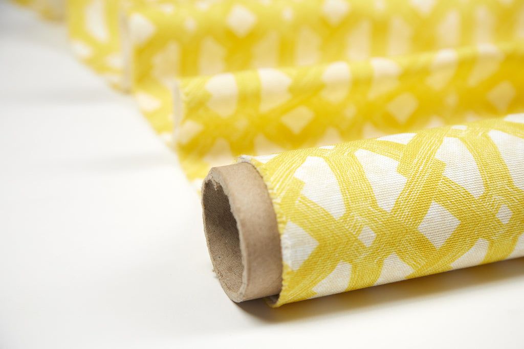 Elegant African batik interior fabric with bright yellow geometric pattern on batik base