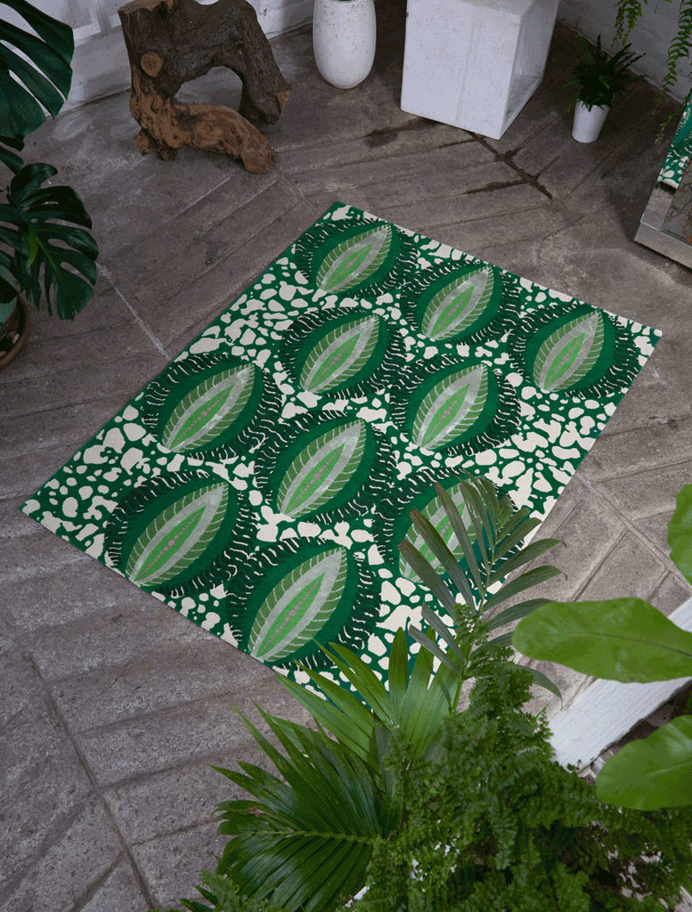 Luxury African rug with vibrant green circular tropical pattern on green batik base handwoven in Nepal