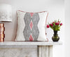 Modern geometric African cushion with bold grey and pink pattern