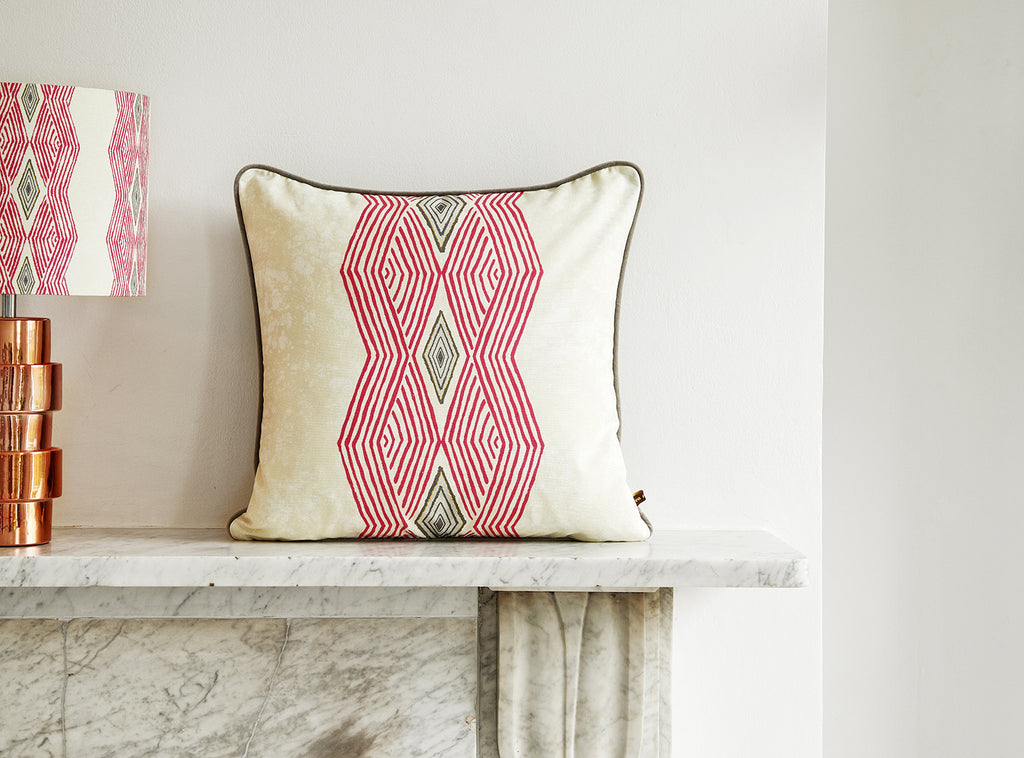 Colourful geometric African cushion with bold vibrant pink pattern