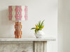 Modern geometric African table lamp with bold pink pattern
